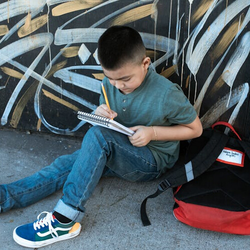 kid writing in notebook